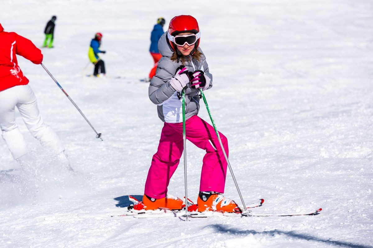 Happy little girl on the ski slope